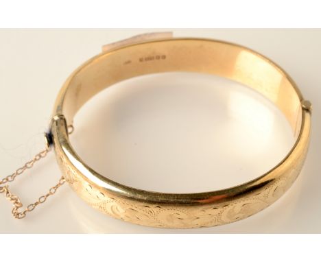 An engraved bangle, 15.6g. Condition Report: 9 carat.