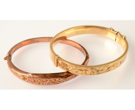 A modern, engraved 9ct. gold bangle and one other 9ct. gold bangle, 19g. 