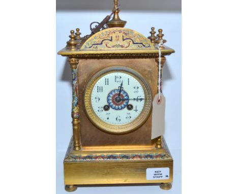 A French gilt brass and champleve mantel clock with an urn finial and standing on four feet.  Height 30.5cm. 