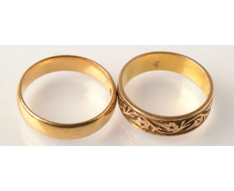 An engraved 18ct. gold band and a plain 22ct. gold band, 7.7g.  Condition Report: Plain band - L, Edwardian 1905, patterned b