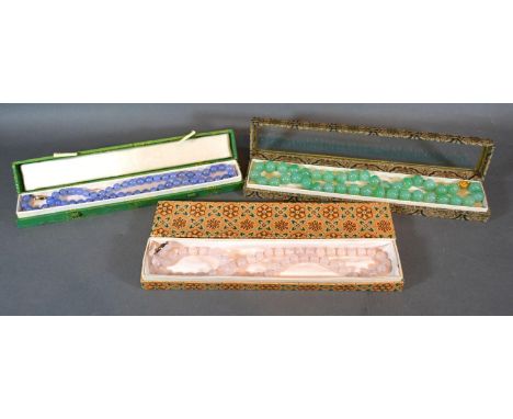A Chinese Green Jade Bead Necklace together with two other similar within boxes 