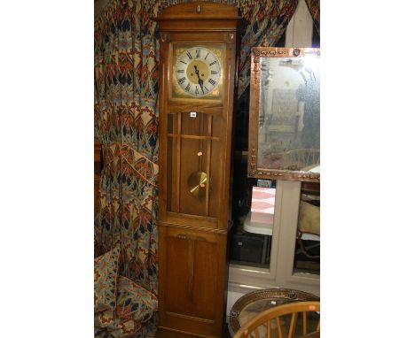 A GOLDEN OAK ARTS & CRAFTS STYLE LONGCASE CLOCK, the 10 inch square silvered dial having Arabic numeral chapter ring with ste