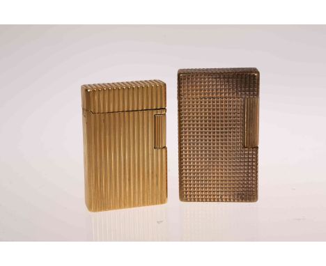 ST. DUPONT, PARIS, AN 18 CARAT GOLD LIGHTER, with reeded case, gross 91 grams, 54mm; and A ST. DUPONT GILT LIGHTER. (2)