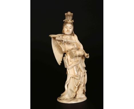 A JAPANESE IVORY OKIMONO, Meiji period (1868-1912), carved as a winged bijin playing a drum, incised marks to base and collec