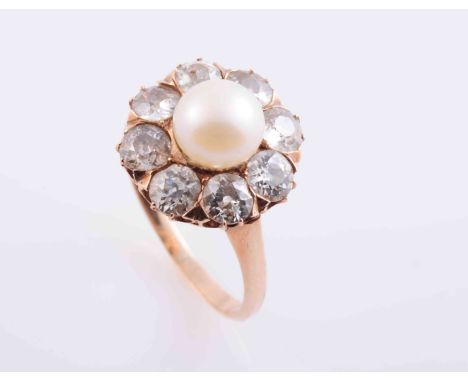A PEARL AND DIAMOND RING, CIRCA 1890, the pearl set within a surround of eight old brilliant cut claw set diamonds, all set i