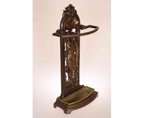 AN VICTORIAN CAST IRON STICKSTAND, the arched panel base cast with the figure of a female water carrier in a surround of styl