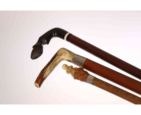 A COLLECTION OF THREE WALKING STICKS, the first with horn handle carved as a horse's hoof, the second with malacca shaft and 