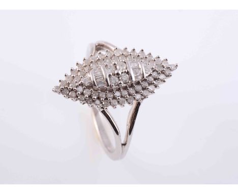 A DIAMOND RING, the marquise shaped mount set to the centre with four brilliant cut diamond highlights and eight rectangular 
