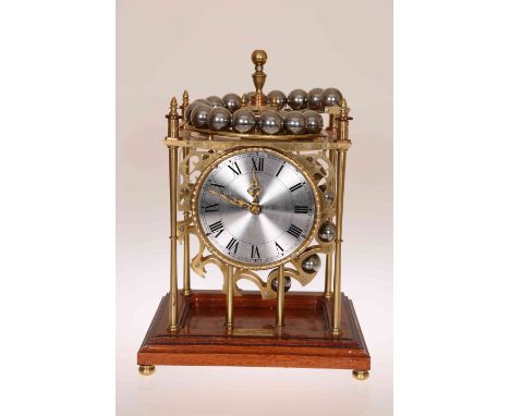 A BRASS BALL BEARING GRAVITY CLOCK BY WILLIAM R. SMITH, the brass open case with knopped and turned pillars and fret pierced 