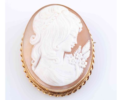 A CAMEO BROOCH, the oval cut carved cameo of the profile of a maiden, collet set in a simple mount with moulded scroll work d