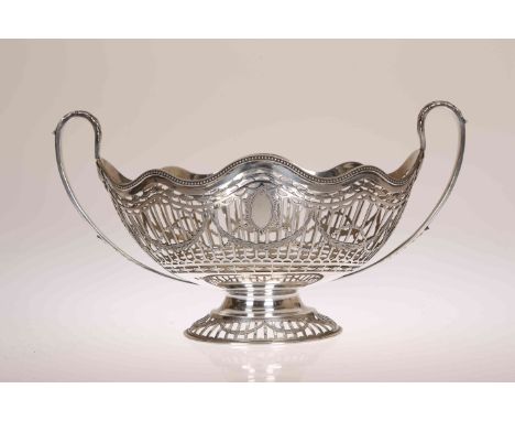 AN ADAM STYLE SILVER TWO-HANDLED BASKET, William Hutton &amp; Sons, Sheffield 1912, oval with undulating beaded rim above pie