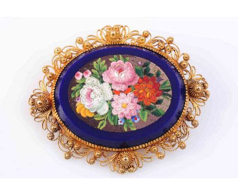 A 19TH CENTURY MICRO MOSAIC BROOCH, the oval mount set to the centre with a floral micro mosaic scene of pink, green, white o