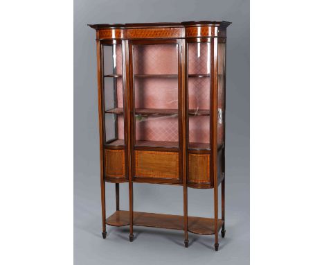 AN EDWARDIAN INLAID MAHOGANY VITRINE, with geometrically inlaid frieze over a glazed door flanked by bowed glass, raised on s