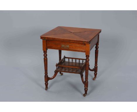 A LATE VICTORIAN MAHOGANY ENVELOPE GAMES TABLE, the square top folding out to reveal a gilt tooled leather playing surface, o