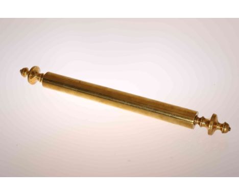 A 19TH CENTURY BRASS SHEET HEATER, cylindrical with turned finial ends. 56.5cm
