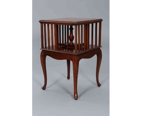 AN EDWARDIAN MAHOGANY REVOLVING BOOKCASE TABLE, the square moulded top above a shelf revolving on a vasiform stem, the table 