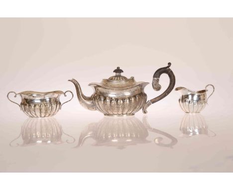 A EDWARDIAN SILVER BACHELORS THREE PIECE TEA SERVICE, maker A.C, Birmingham 1904, comprising teapot, cream jug and two-handle