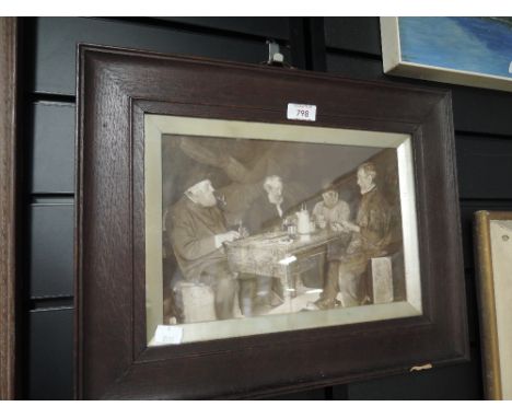 A vintage photographic print of working men playing cards