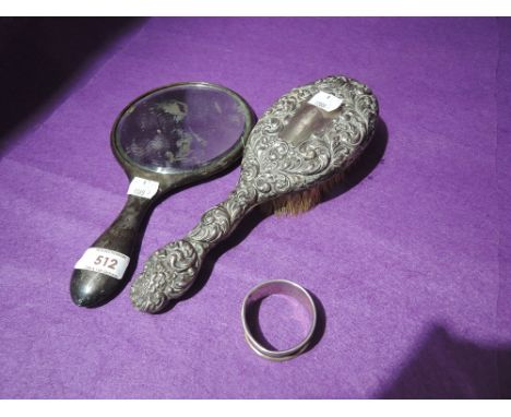 A white metal dressing table mirror, brush and napkin ring (probably silver)