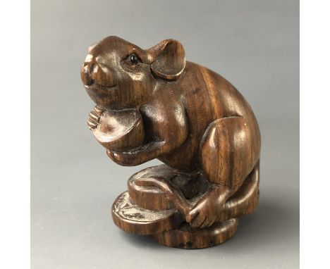 A Japanese carved wood netsuke modelled as a rat