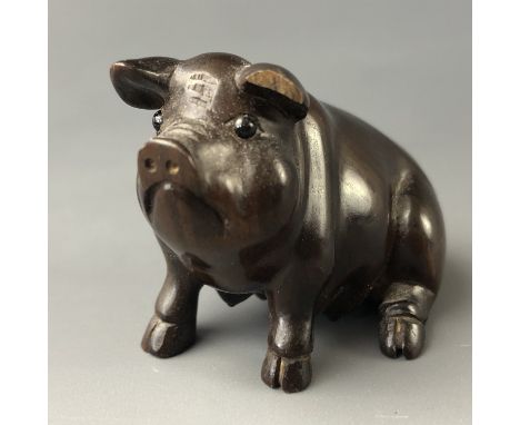 A Japanese carved wood netsuke modelled as a pig