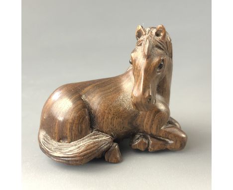 A Japanese carved wood netsuke modelled as a pony