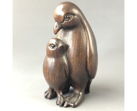 A Japanese carved wood netsuke modelled as penguins