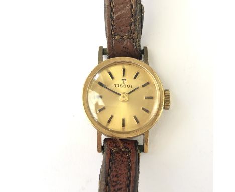 A lady's 9ct gold cased Tissot wrist watch, with gilt circular dial and baton markers, 10.8g total 