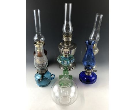 An Aladdin oil lamp, four other oil lamps, a candle lamp etc