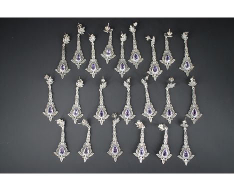 Eleven pairs of 'new old stock' white metal (tests as silver) marcasite and amethyst ear pendants, stamped '925', (each pair 