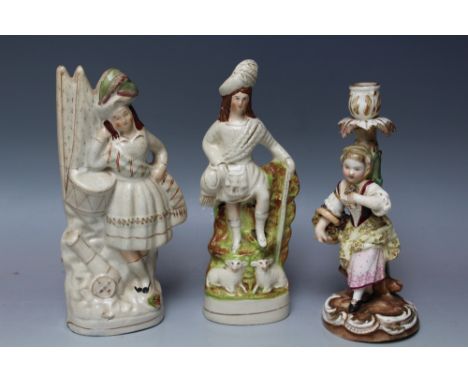 TWO SCOTTISH THEMED STAFFORDSHIRE FLATBACK TYPE FIGURES, together with a Continental style candlestick with marks to base, H 