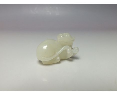 A SMALLER ORIENTAL CARVED WHITE JADE DOG FIGURE, W 3.6 cmCondition Report:Origin or treatments of this jade item unknown.