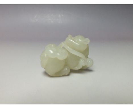 AN ORIENTAL CARVED WHITE JADE DOG FIGURE, W 4 cmCondition Report:Origin or treatments of this jade item unknown.