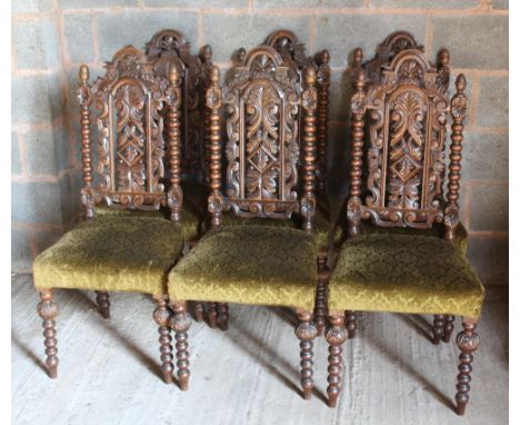 A SET OF SIX VICTORIAN OAK BOBBIN TURNED CHAIRS IN THE JACOBEAN STYLE, the carved pierced backs above upholstered seats  (6)