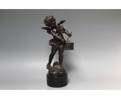 A BRONZE FIGURE OF A WINGED CHERUB PLAYING A DRUM,  H 34 cm