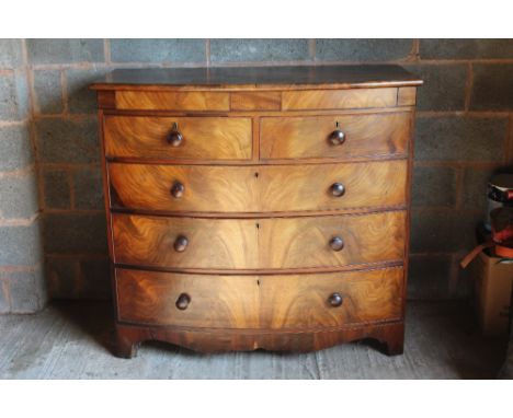 A 19TH CENTURY MAHOGANY BOW FRONTED CHEST, having two short above three longer graduated drawers, raised on shaped bracket fe