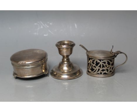 A HALLMARKED SILVER JEWELLERY BOX,  together with a filled squat candlestick, both A/F and a hallmarked silver pierced mustar