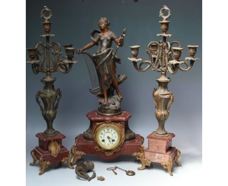 A LATE 19TH / EARLY 20TH CENTURY FRENCH CLOCK GARNITURE, the enamel face with Arabic numerals and floral garland decoration, 