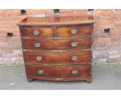 A LATE GEORGIAN MAHOGANY BOW FRONTED CHEST, having two short above three longer graduated drawers, raised on short bracket fe