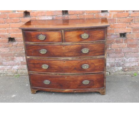 A LATE GEORGIAN MAHOGANY BOW FRONTED CHEST, having two short above three longer graduated drawers, raised on short bracket fe