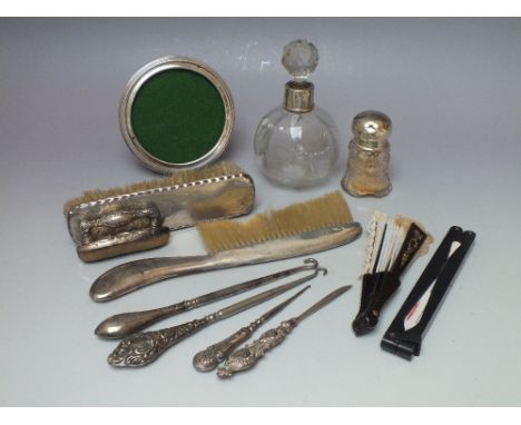 A COLLECTION OF SILVER AND OTHER DRESSING TABLE / VANITY ITEMS, to include a hallmarked circular mirror, button hooks, nail b