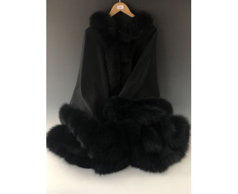 A lady's black wool hooded evening cloak with fox fur trim