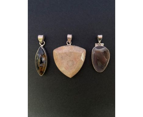 Three contemporary silver / white metal (tests as silver) and polished stone pendants, including a fossil coral drop, 4 cm