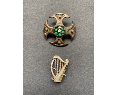 A silver and Connemara marbled Celtic harp brooch, together with a cruciform brooch centred by a cane glass cabochon