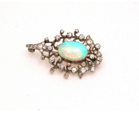 A late Victorian opal and diamond brooch, centred with a white opal cabochon displaying a pleasing play of mostly green and o