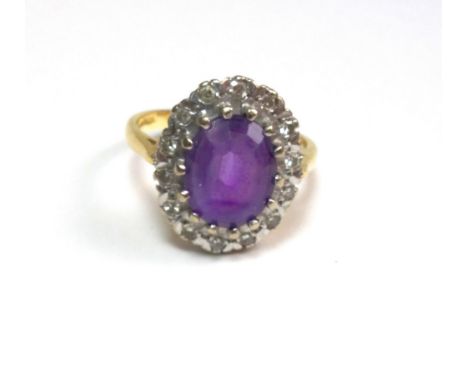 A vintage 18ct gold, amethyst and diamond oval cluster ring, centred with an oval mixed-cut amethyst, claw set within a small