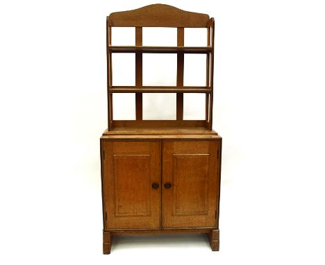 A golden oak and ebony strung cupboard with bookshelves over, by Peter Waals, circa 1930, the low cupboard with exposed dovet