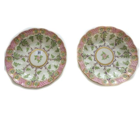 A pair of Royal Worcester shaped circular soup plates, painted with flowers, leaves and leaf scrolls, pink diaper borders and