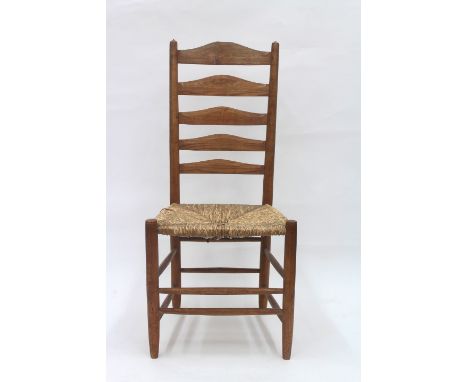 An ash framed ladder back chair with rush seat, 'The Gimson Chair', after a design by Ernest Gimson, 105cm high.