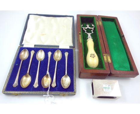 A cased set of six silver teaspoons, Sheffield 1962, with shaped stems, a plain rectangular silver match box sleeve, London 1